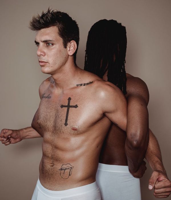 Man performing a controlled bodyweight exercise in a minimalist gym.