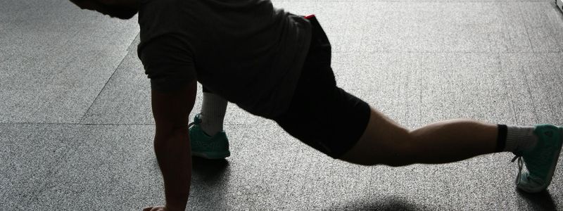 Man stretching his legs after a workout session.